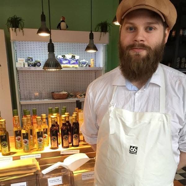 Gulli at work in a local butcher shop in Iceland, greeting visitors.